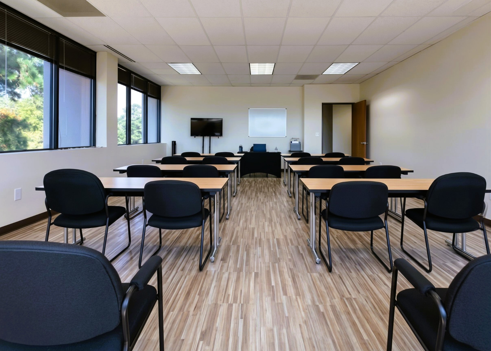 Empty Suite 350 meeting room set classroom-style with tables and chairs